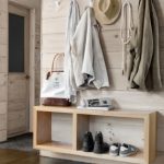 simple solution a floating pine shelf offers a spot for bags shoes and mail in the entrance hallway of this massachusetts cabin steel hooks from the land of nod corral coats scarves and more